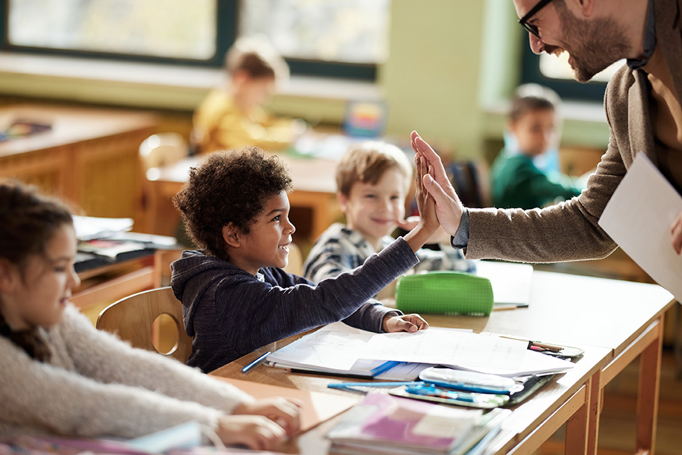 student gives teacher a high-five
